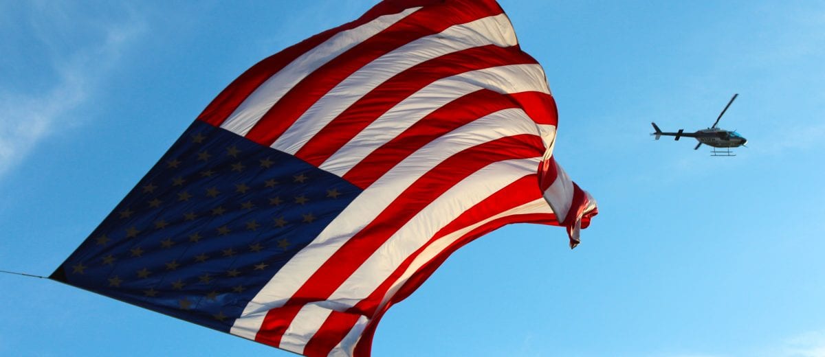 photo of american flag and helicopter